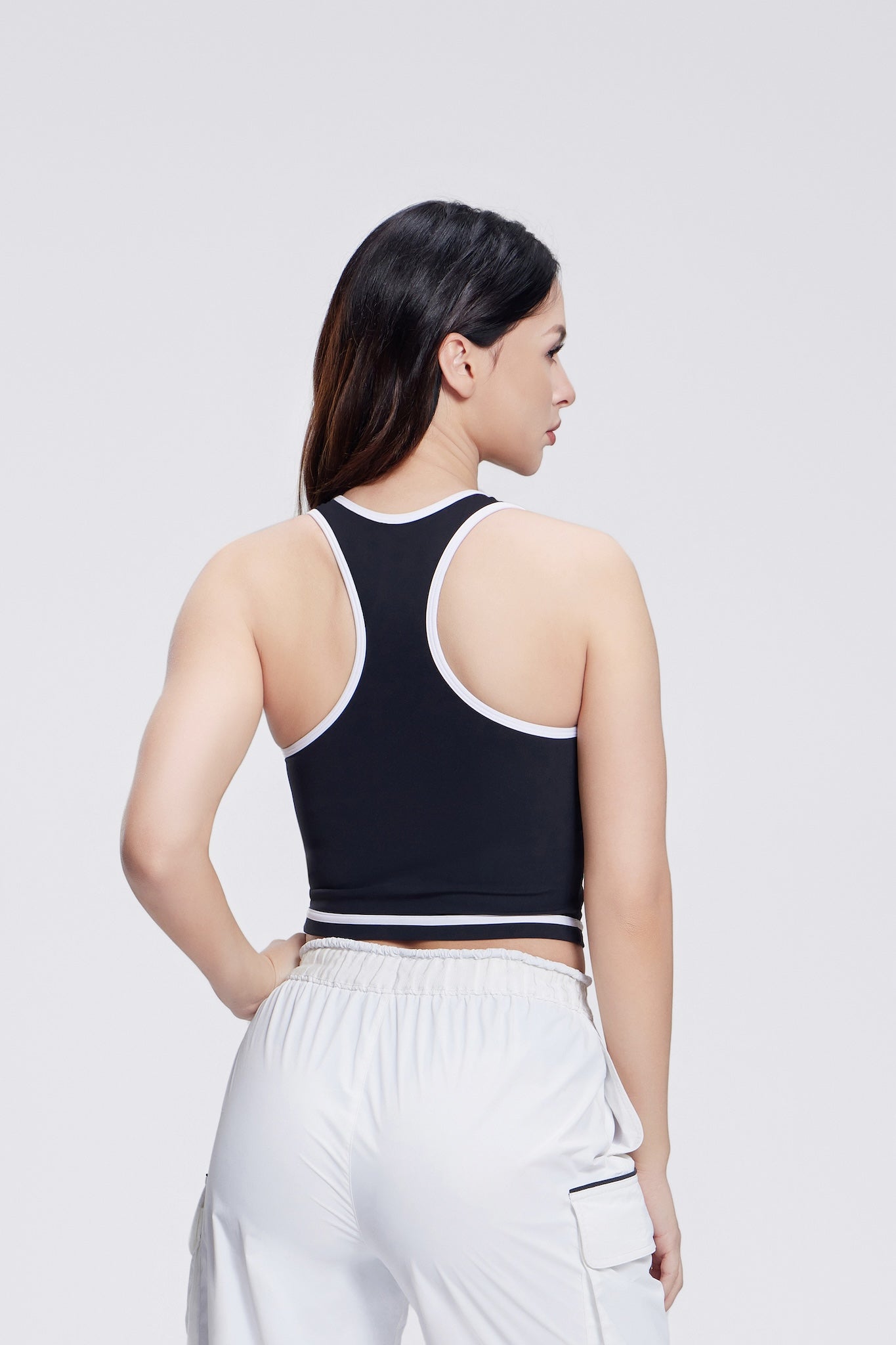 Line Series Racerback Sports Tank for women in a sleek black design. Features a racerback cut for full range of motion, breathable fabric, and a fitted silhouette, ideal for workouts and active wear.”