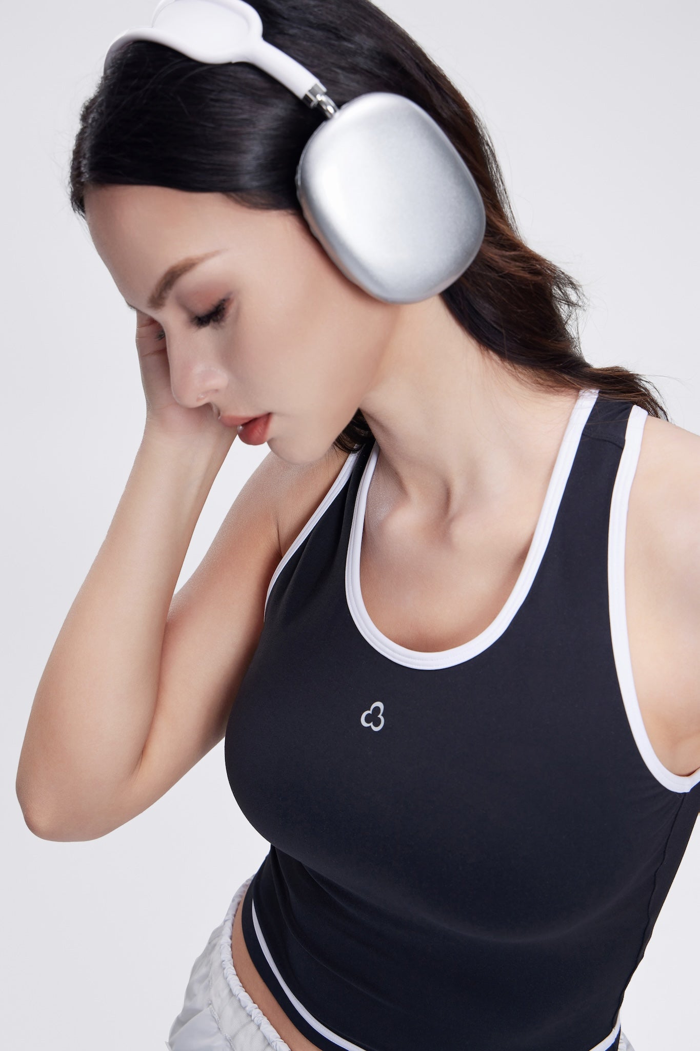 Line Series Racerback Sports Tank for women in a sleek black design. Features a racerback cut for full range of motion, breathable fabric, and a fitted silhouette, ideal for workouts and active wear.