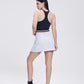 Chic Side Split Tennis Skirt for women in a crisp white color. Features a high waistband, side splits for enhanced movement, and built-in shorts for comfort and coverage, perfect for tennis and active wear.