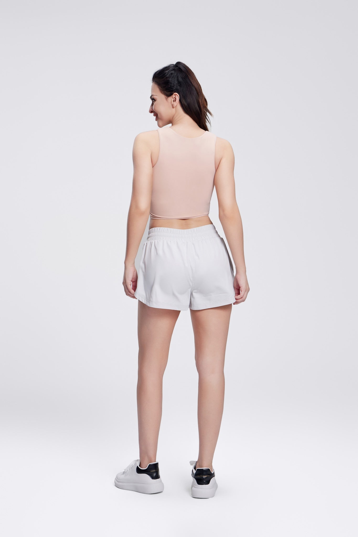 White female shorts with zipper side pockets and built-in compression shorts