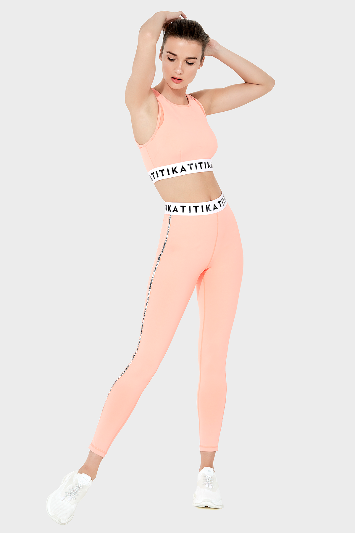 Front view of a woman wearing Titika Active Wear’s sleek, high-waisted black leggings with mesh panels, designed for comfort and breathability during workouts.