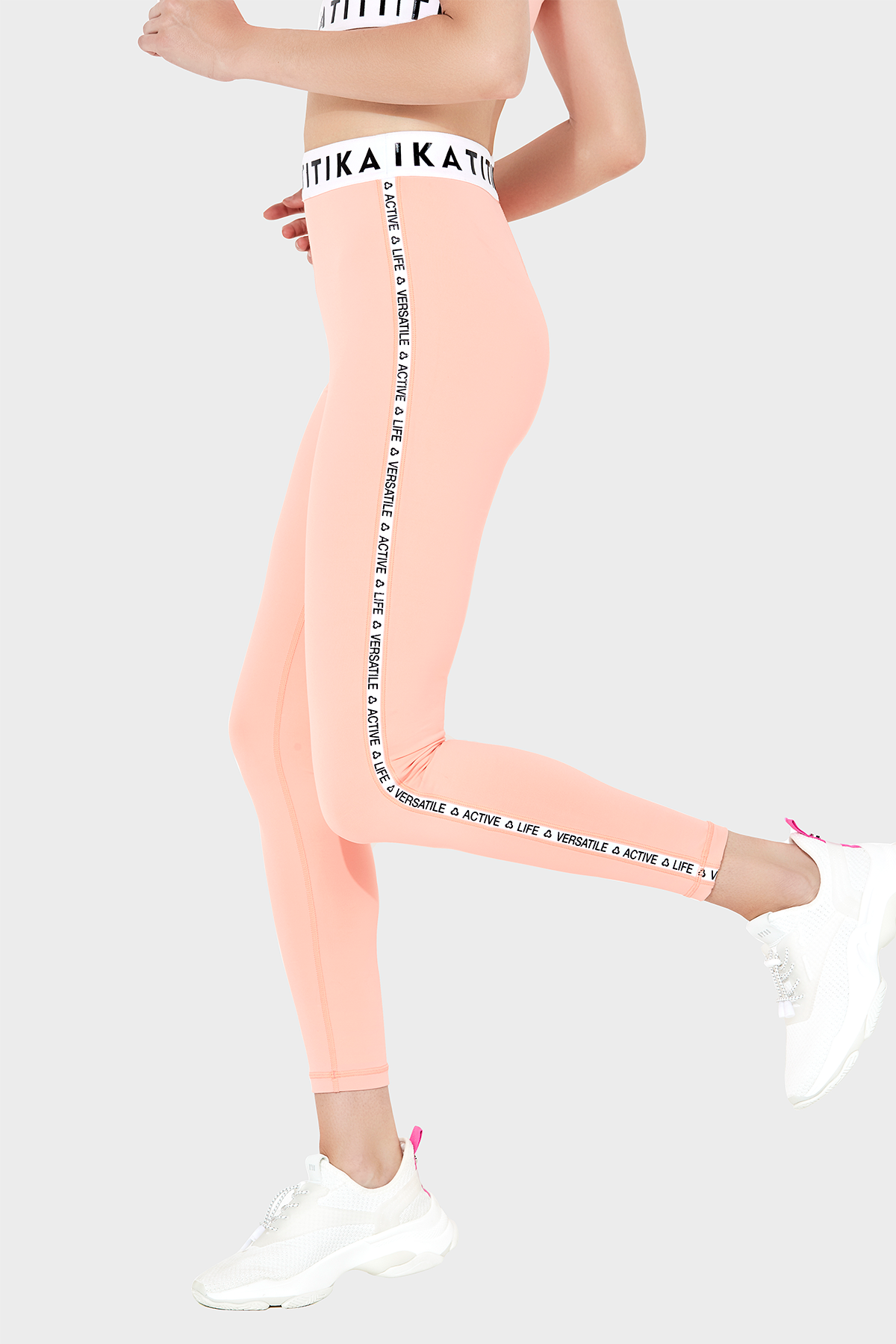 Front view of a woman wearing Titika Active Wear’s sleek, high-waisted black leggings with mesh panels, designed for comfort and breathability during workouts.
